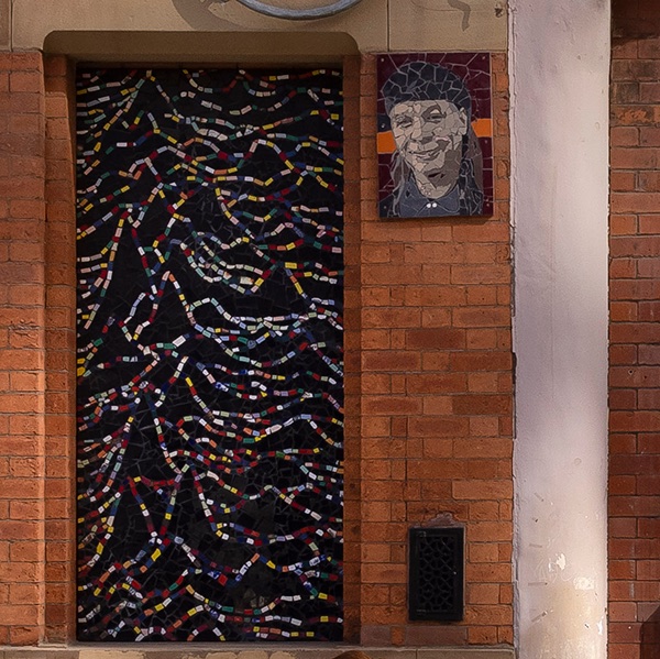 Mark Kennedy’s tiled mosaic of the Unknown Pleasures cover on an exterior wall at Afflecks in Manchester