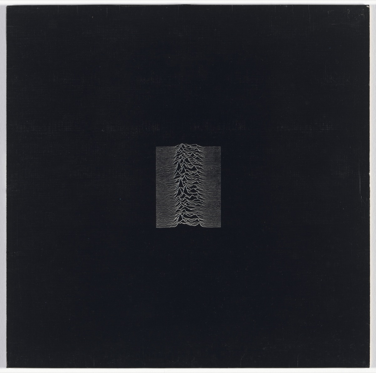 The original Unknown Pleasures album sleeve: white stacked pulse lines on a black square